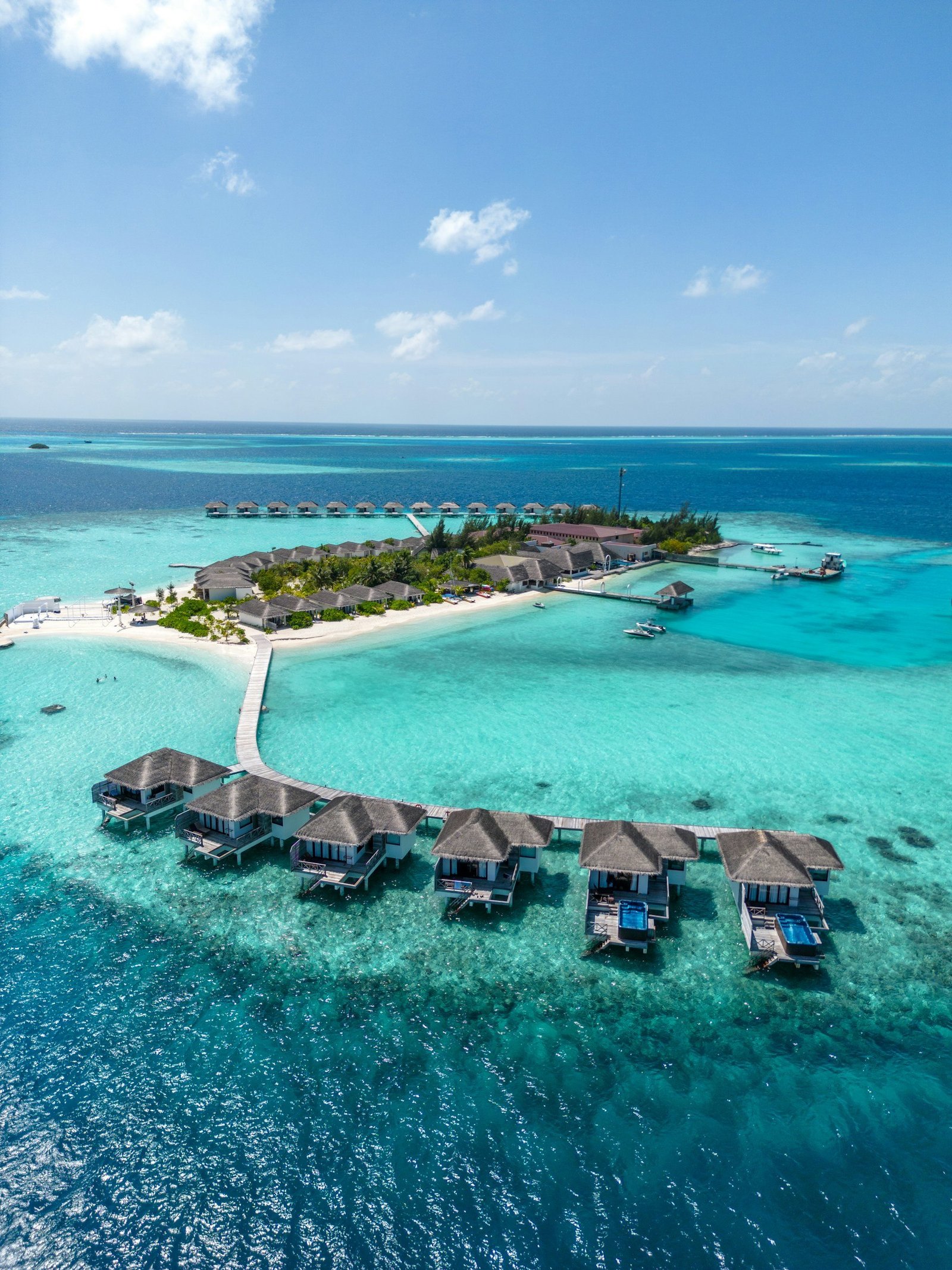 Overwater villas beside a turquoise Maldives lagoon
